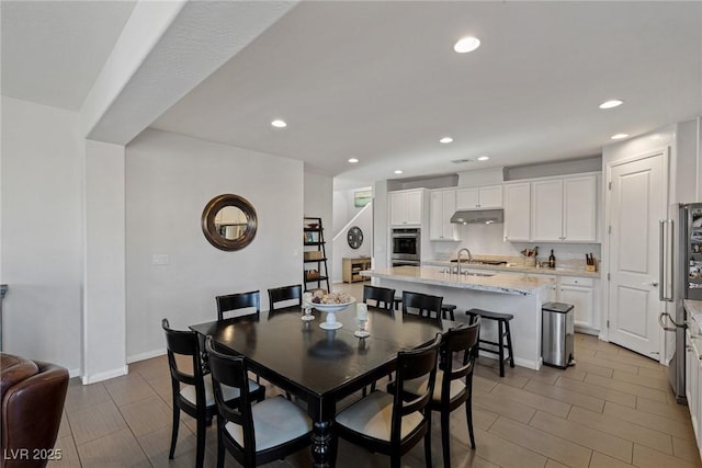 dining room with baseboards and recessed lighting