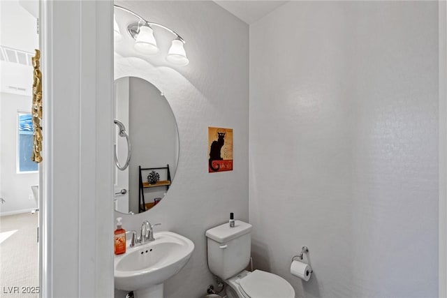 bathroom with visible vents, a sink, and toilet