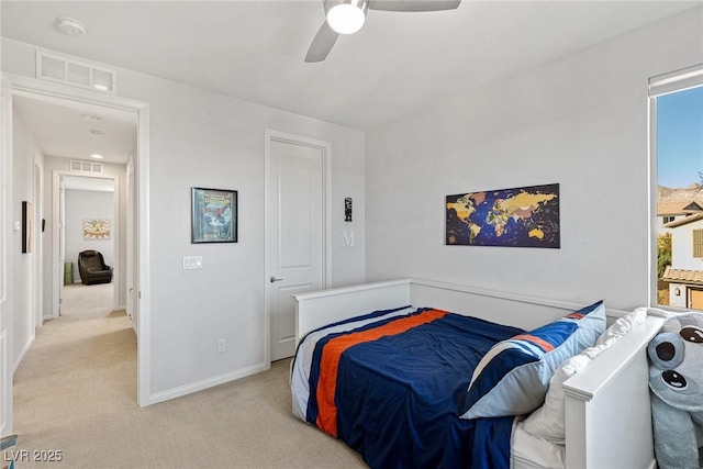 bedroom with baseboards, visible vents, a ceiling fan, and light colored carpet