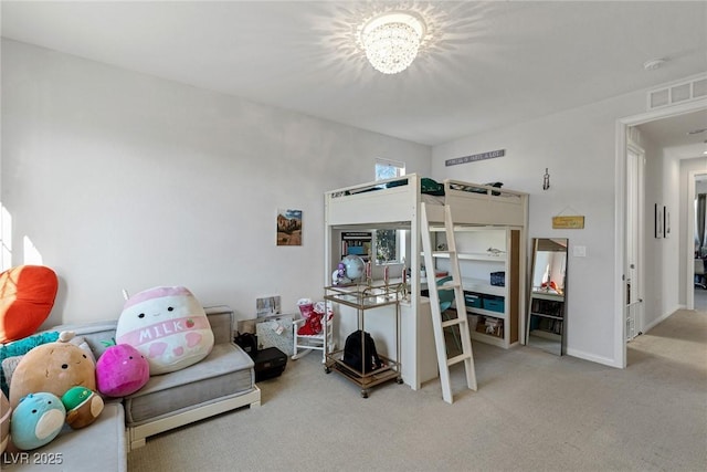 carpeted bedroom featuring a chandelier, visible vents, and baseboards