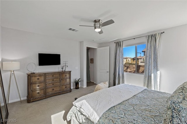 bedroom featuring baseboards, visible vents, a ceiling fan, and light colored carpet