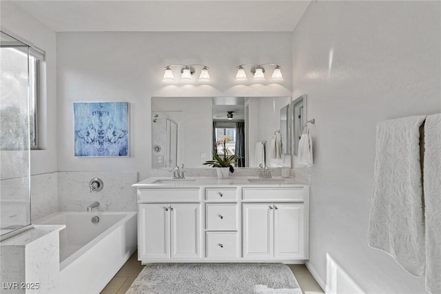 full bathroom with a bath, double vanity, and a sink