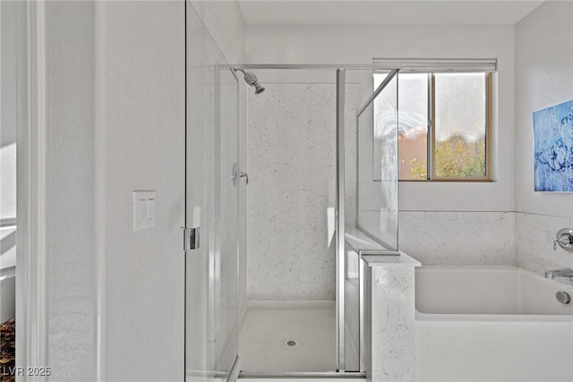 full bathroom featuring a stall shower and a garden tub