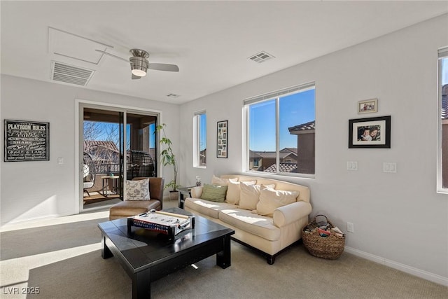 living room featuring baseboards, carpet, visible vents, and a ceiling fan