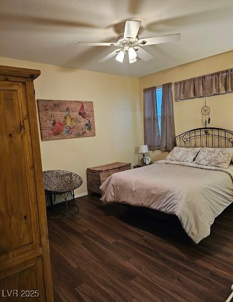 bedroom featuring ceiling fan, baseboards, and wood finished floors