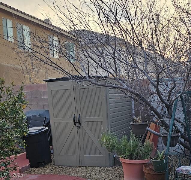 outdoor structure at dusk featuring a shed and an outdoor structure