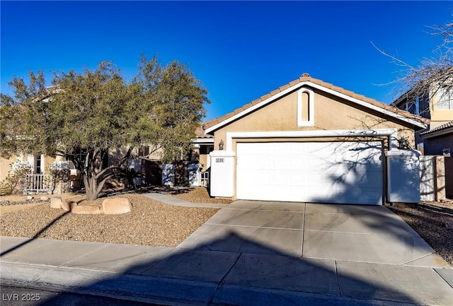 view of front of property with a garage, concrete driveway, a tiled roof, and stucco siding