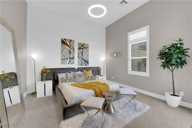 bedroom with visible vents, light carpet, and baseboards