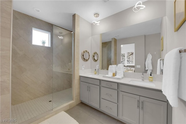 full bath with a walk in shower, double vanity, a sink, and tile patterned floors