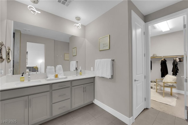 bathroom with tile patterned floors, visible vents, a sink, and double vanity