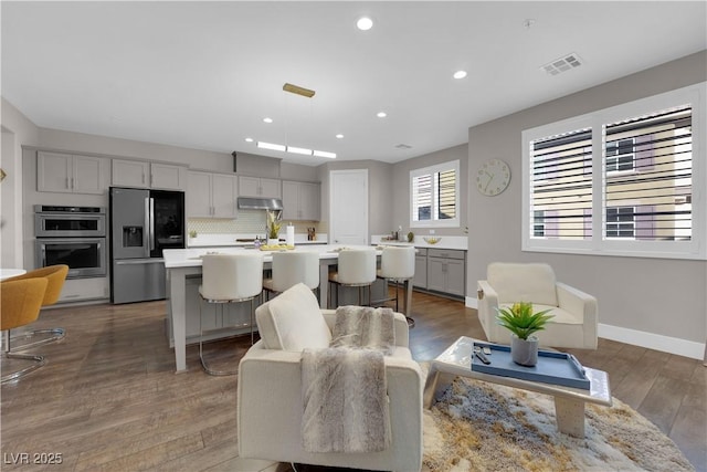 interior space with dark wood-style floors, baseboards, visible vents, and recessed lighting