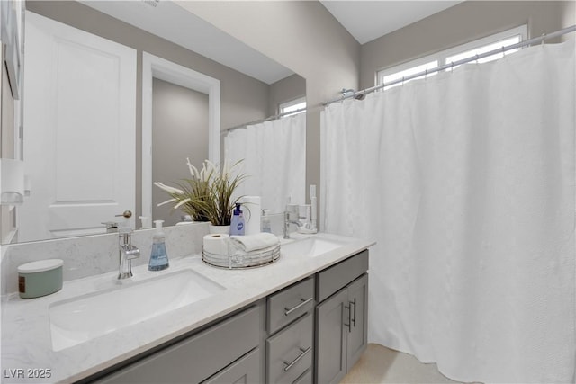 full bath featuring double vanity and a sink