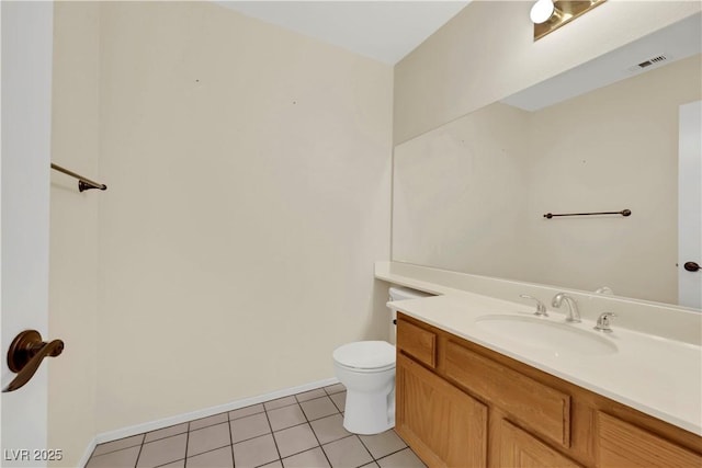 half bathroom with toilet, tile patterned flooring, baseboards, and vanity