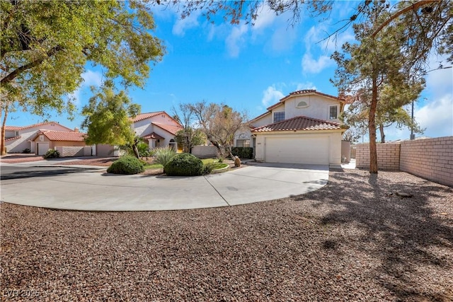 view of front of home featuring a tile roof, stucco siding, concrete driveway, fence, and a garage