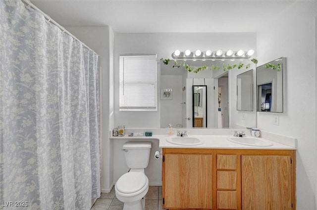 bathroom with tile patterned flooring, a sink, toilet, and double vanity