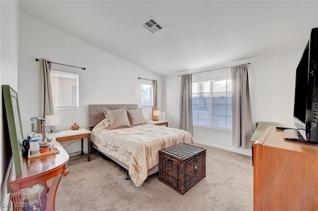 bedroom with lofted ceiling, light carpet, visible vents, and baseboards