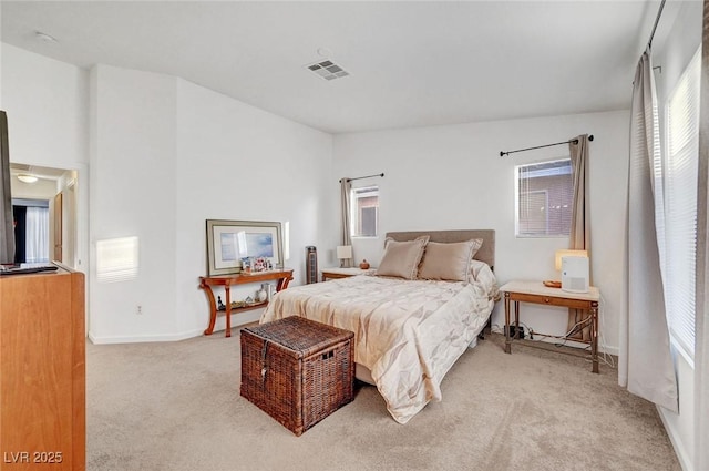 bedroom with light colored carpet, visible vents, lofted ceiling, and multiple windows