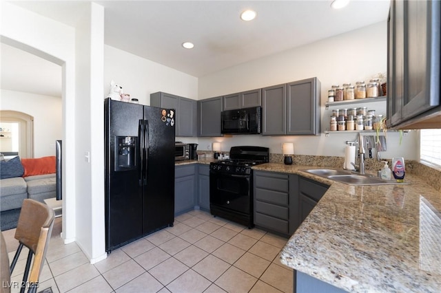 kitchen featuring gray cabinetry, black appliances, open shelves, a sink, and light tile patterned flooring