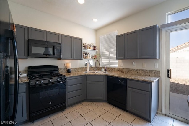 kitchen featuring black appliances, gray cabinets, a sink, and a healthy amount of sunlight