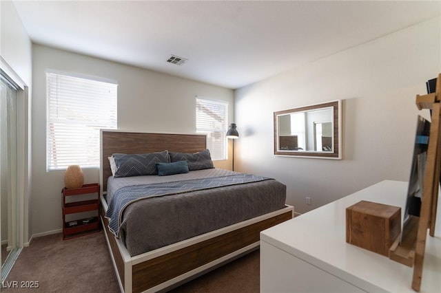 bedroom with visible vents and dark colored carpet