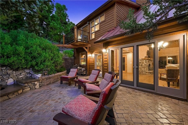 view of patio with french doors and a balcony