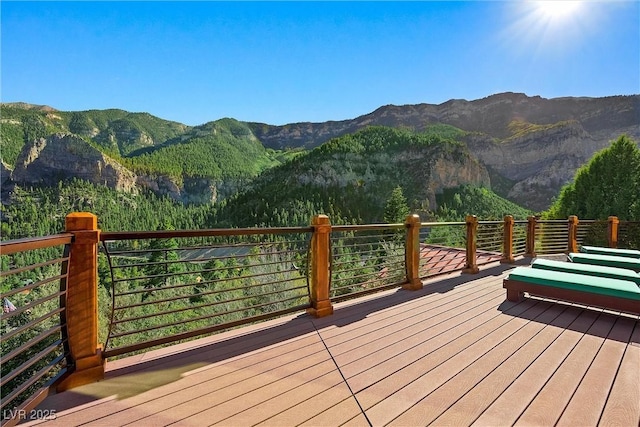 wooden deck with a mountain view