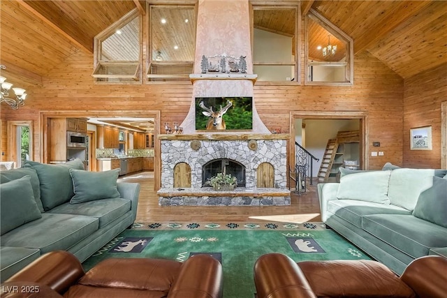 living room with wood ceiling, wood finished floors, an inviting chandelier, wood walls, and a fireplace