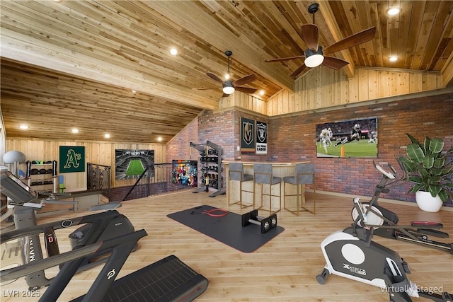 gym with light wood-type flooring, lofted ceiling, wood ceiling, and brick wall