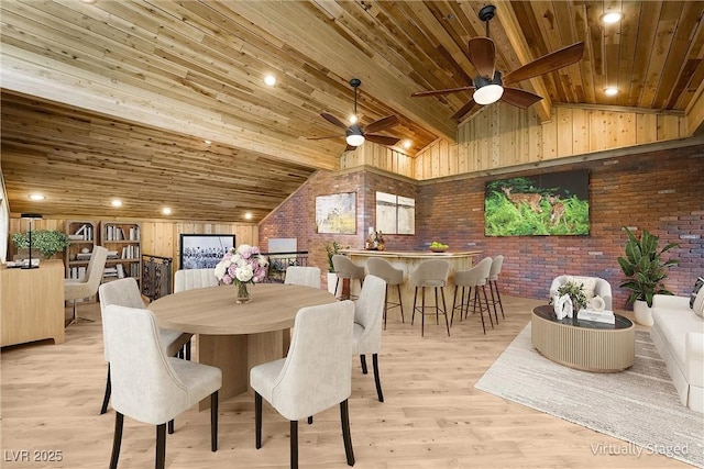 dining space with lofted ceiling, brick wall, wood ceiling, light wood-style flooring, and ceiling fan