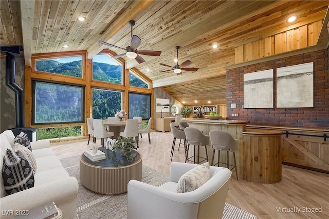 living room featuring high vaulted ceiling, a mountain view, recessed lighting, wood ceiling, and light wood finished floors