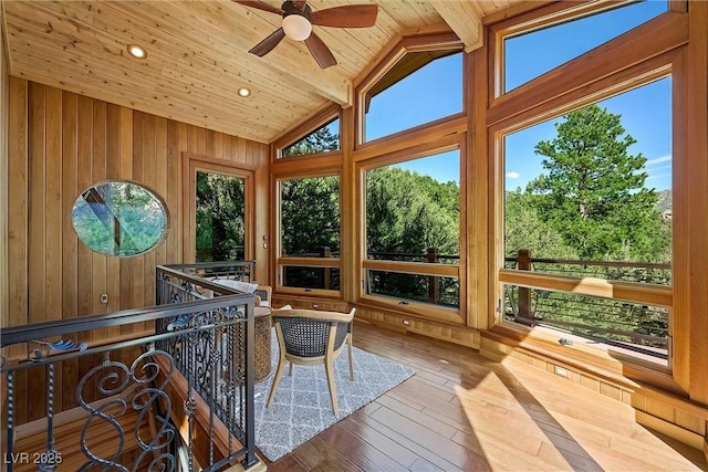 unfurnished sunroom with wooden ceiling, ceiling fan, and vaulted ceiling