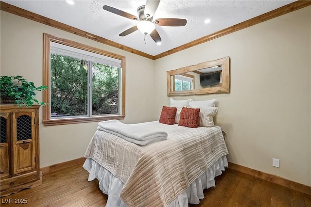 bedroom featuring a textured ceiling, wood finished floors, a ceiling fan, baseboards, and crown molding