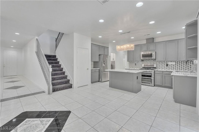 kitchen with light countertops, appliances with stainless steel finishes, and gray cabinets