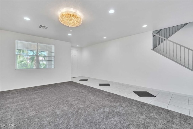 spare room with light tile patterned floors, recessed lighting, visible vents, and light colored carpet