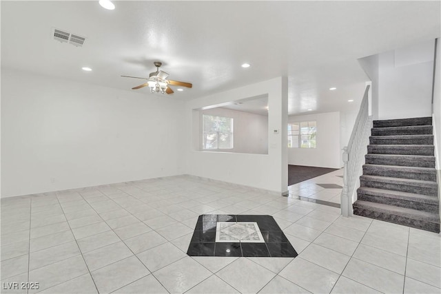 interior space featuring light tile patterned floors, stairway, visible vents, and recessed lighting