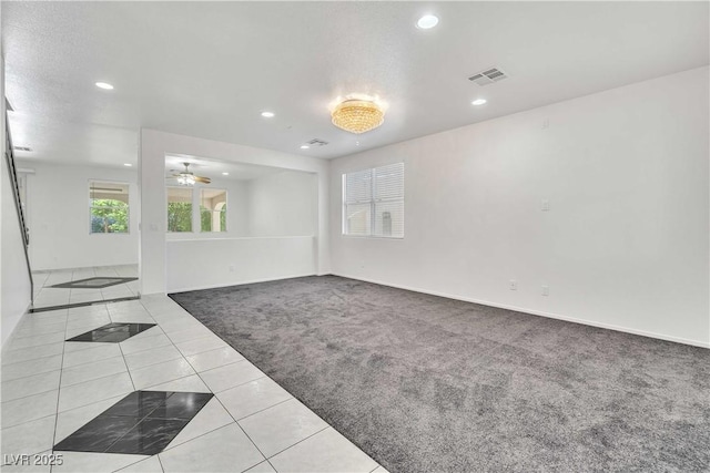 empty room featuring visible vents, a ceiling fan, light colored carpet, light tile patterned flooring, and recessed lighting