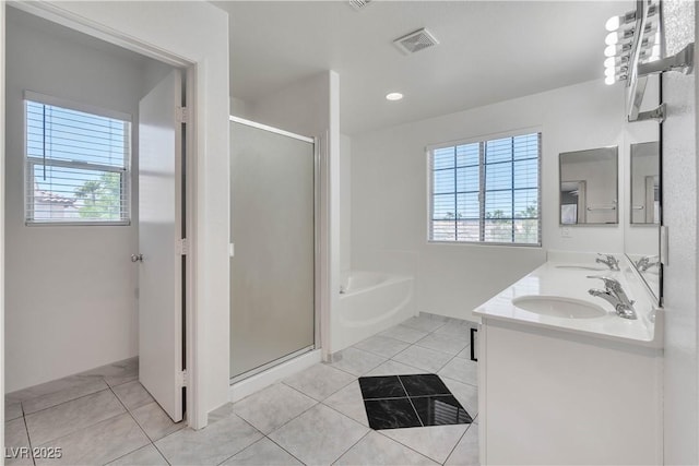 full bath featuring a garden tub, visible vents, a sink, and tile patterned floors