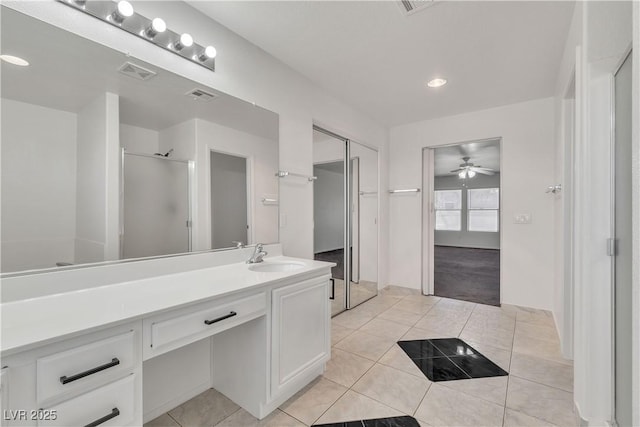 bathroom featuring visible vents, a ceiling fan, a stall shower, vanity, and tile patterned floors