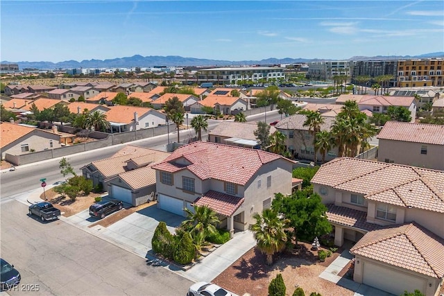 drone / aerial view featuring a residential view and a mountain view