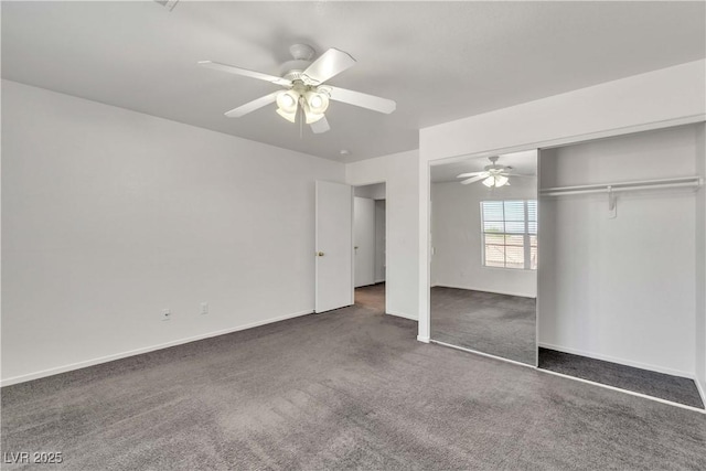 unfurnished bedroom with a ceiling fan, dark colored carpet, a closet, and baseboards