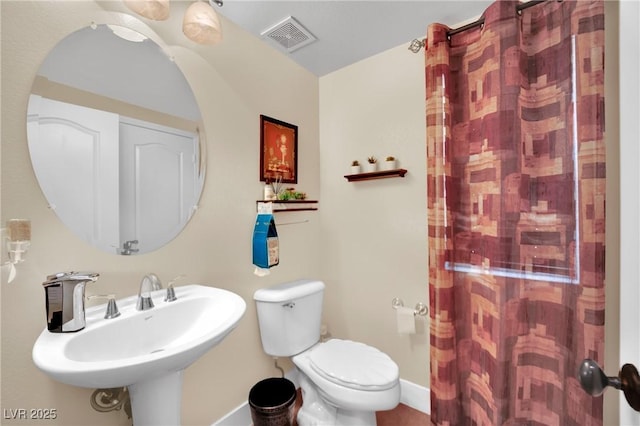 bathroom featuring baseboards, visible vents, a sink, and toilet