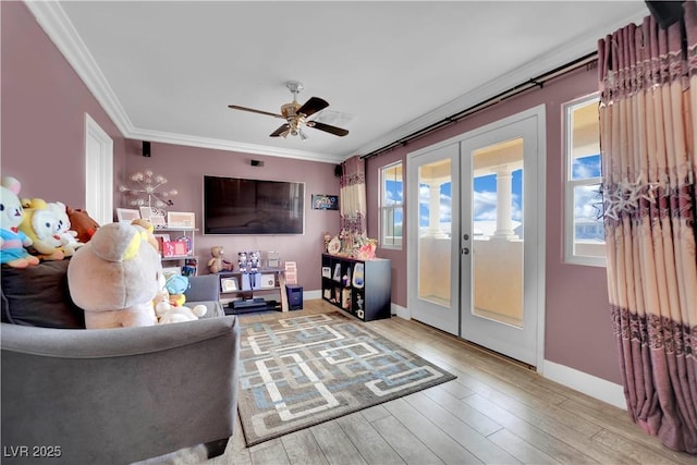 living area with ornamental molding, french doors, light wood-style flooring, and baseboards