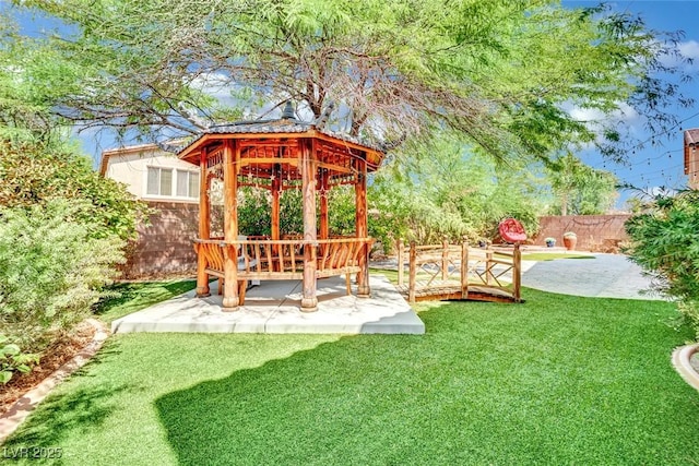 view of yard featuring fence, a patio, and a gazebo