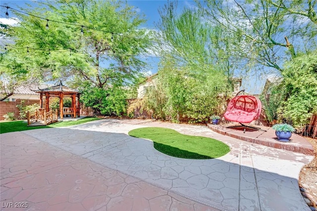 view of yard featuring a fenced backyard, a patio, and a gazebo