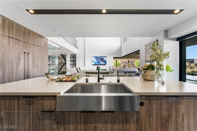 kitchen with light countertops, a sink, and modern cabinets