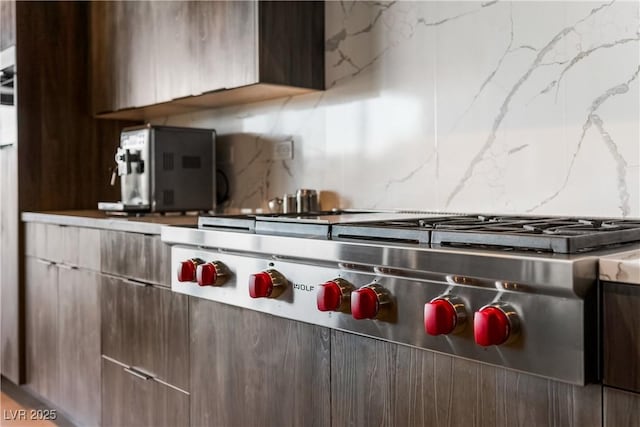 kitchen featuring stainless steel gas cooktop, modern cabinets, and decorative backsplash