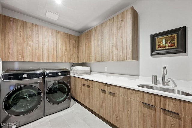 clothes washing area with washer and dryer, cabinet space, a sink, and light tile patterned floors