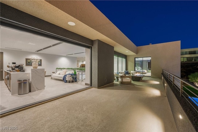 patio at twilight featuring an outdoor living space