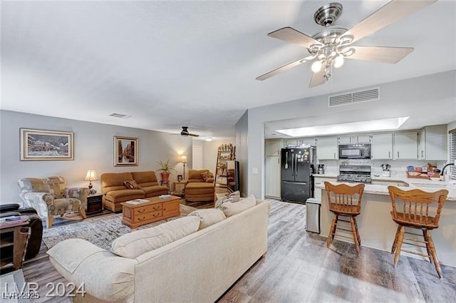 478 Potomac St, Henderson, NV 89015 - living room featuring a ceiling fan, visible vents, and light wood finished floors