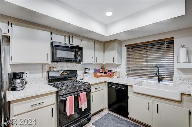 478 Potomac St, Henderson, NV 89015 - kitchen with black appliances, light stone counters, and a sink